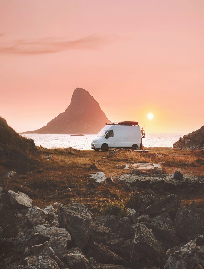 Van car camper at sunset ocean beach road trip in Norway caravan RV trailer travel on wheels vacations camping outdoor van life