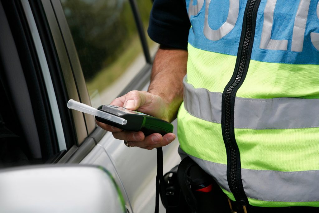 Policeman holding device for checking alcohol intoxication 