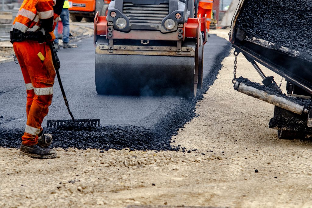 Workers paving a road with asphalt 