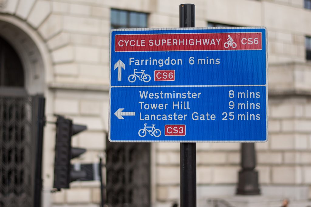 A street sign in London directs cyclists along the Cycle Superhighway CS6 and CS3 towards Farringdon, Westminster, Lancaster Gate and Tower Hill