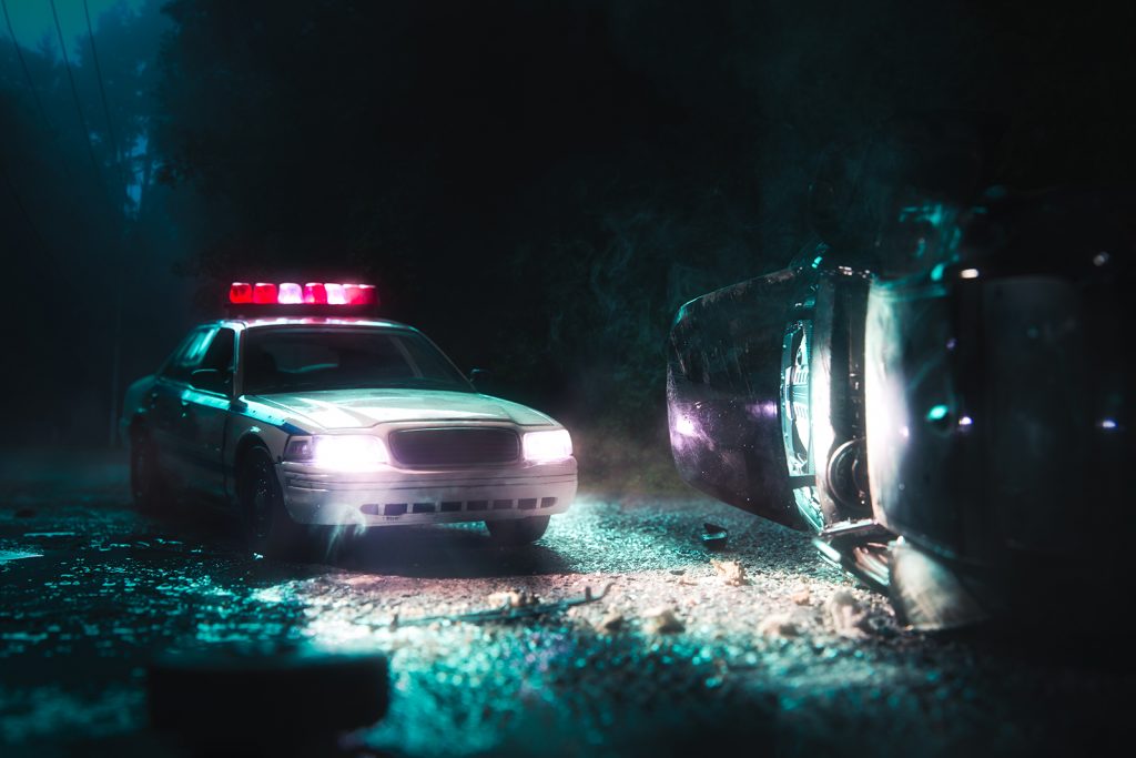 High contrast image of a police car arriving near a car crash / scale model scene